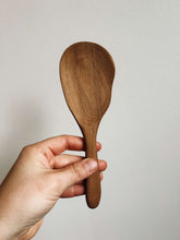 Load image into Gallery viewer, Hand holding a wooden spoon against a plain background
